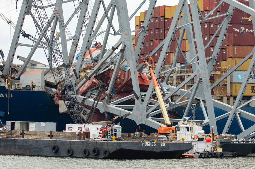 In this photo provided by the U.S. Army Corps of Engineers, salvors with the Unified Command prepare charges for upcoming precision cuts to remove Section 4 from the port side of the bow of the Dali container ship, May 7, 2024, during the Key Bridge Response, in Baltimore. Debris and wreckage removal is ongoing in support of safely and efficiently opening the Fort McHenry Channel, following the Francis Scott Key Bridge’s March 26 collapse. (Christopher Rosario/U.S. Army Corps of Engineers via AP)