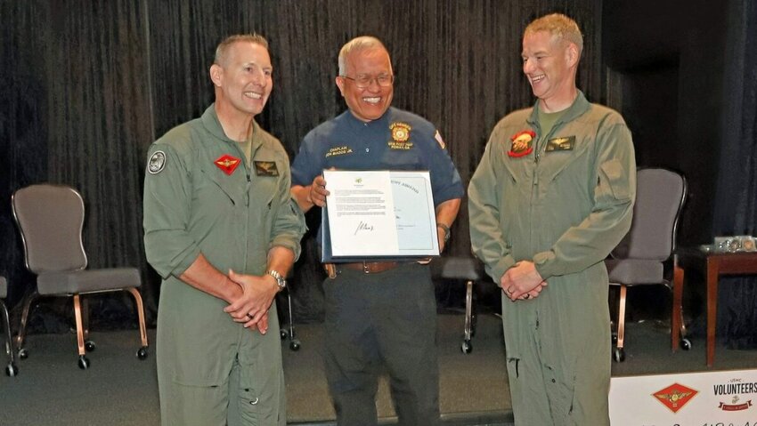 Don Biadog Jr., center, a retired Navy chaplain, is presented with the U.S. President’s Lifetime Achievement award.