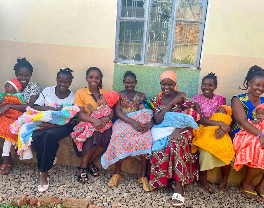 Ugandan ladies pose for a photo with blankets that IMB missionary Rebekah Lockhart crocheted for them while she recovered from leukemia in the United States. Her husband, Eric, made two trips back to Uganda while she remained in the U.S. and took them to a friend who has a foundation for moms. (Photo/IMB)