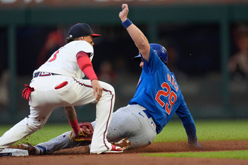 Atlanta Braves' Orlando Arcia tags out Chicago Cubs' Michael Busch on a steal attempt at second base in the second inning Monday, May 13, 2024, in Atlanta. (AP Photo/John Bazemore)