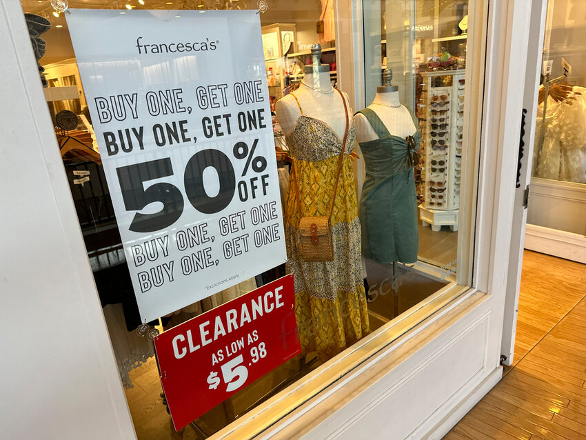 A sign trumpets discounts available in a clothing store in a mall Monday, April 29, 2024, in Lone Tree, Colo. (AP Photo/David Zalubowski)