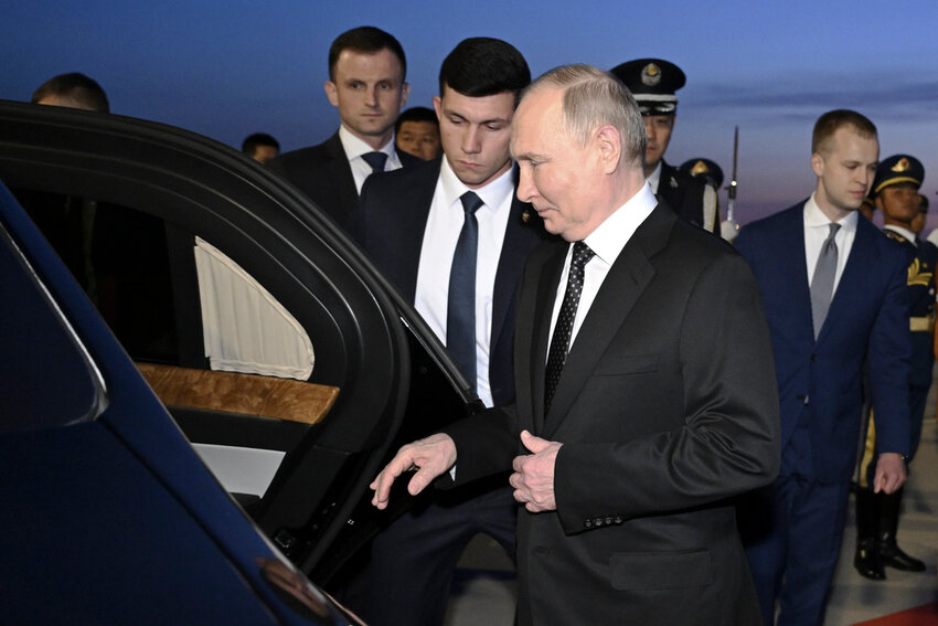 Russia's President Vladimir Putin, foreground, gets into a vehicle upon arrival at the Beijing Capital International Airport in Beijing, Thursday, May 16, 2024. (Yue Yuewei/Xinhua via AP)