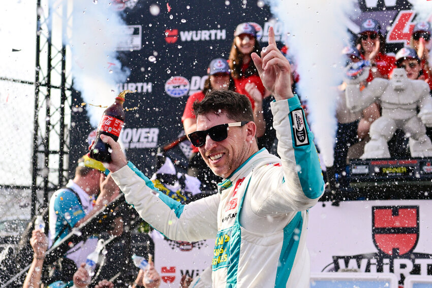 Denny Hamlin celebrates in Victory Lane after winning a NASCAR Cup Series race at Dover Motor Speedway, Sunday, April 28, 2024, in Dover, Del. (AP Photo/Derik Hamilton)