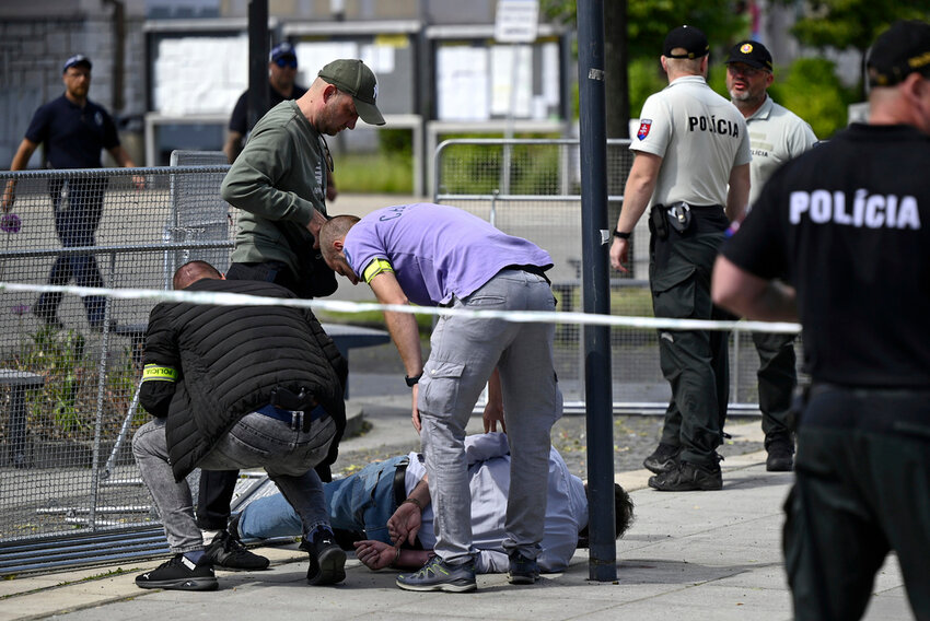 Police arrest a man after Slovak Prime Minister Robert Fico was shot and injured following the cabinet's away-from-home session in the town of Handlova, Slovakia, Wednesday, May 15, 2024. (Radovan Stoklasa/TASR via AP)
