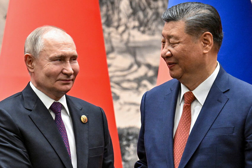 Chinese President Xi Jinping, right, and Russian President Vladimir Putin shake hands prior to their talks in Beijing, China, on Thursday, May 16, 2024. (Sergei Bobylev, Sputnik, Kremlin Pool Photo via AP)