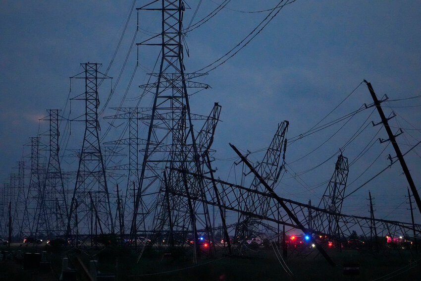 Transmission power lines are down near the Grand Parkway and West Road after a storm Thursday, May 16, 2024, in Cypress, Texas. (Melissa Phillip/Houston Chronicle via AP)
