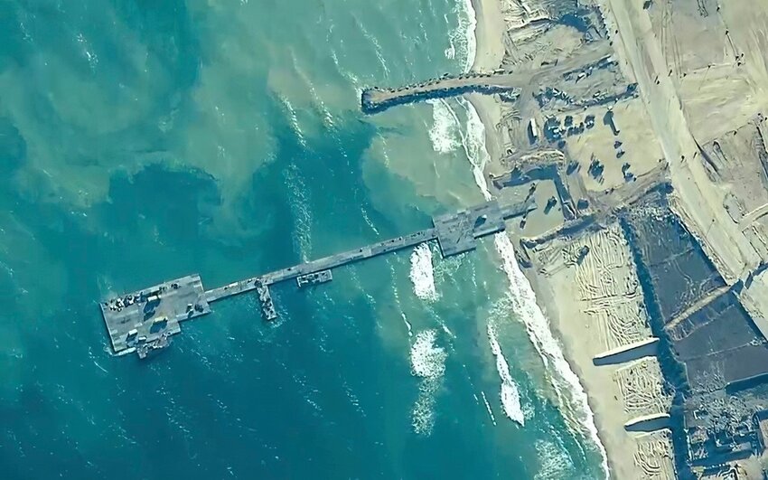 U.S. Army soldiers, U.S. Navy sailors and Israel Defense Forces troops place the Trident Pier on the coast of Gaza Strip on Thursday, May 16, 2024. (U.S. Central Command via AP)
