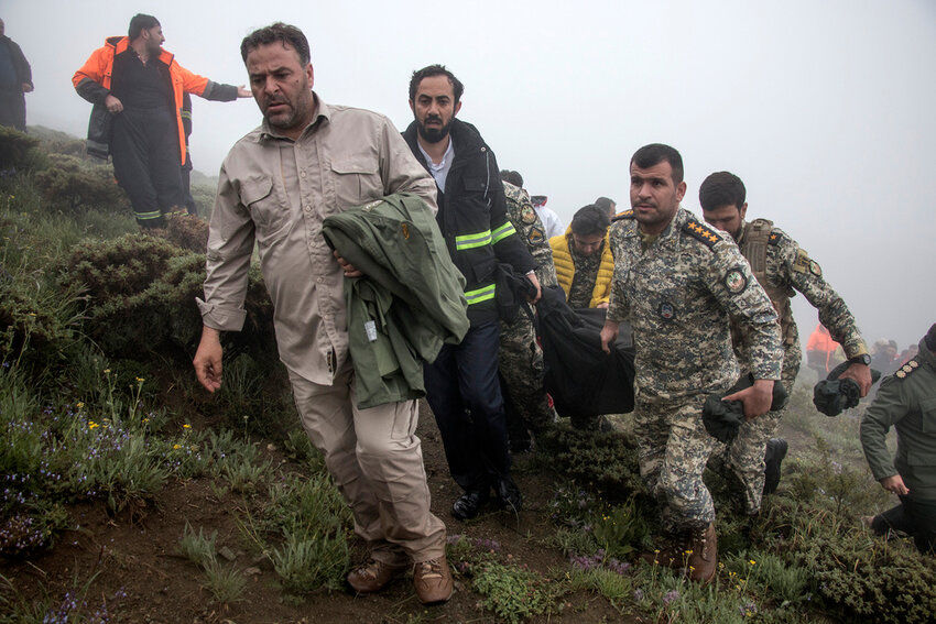 In this photo provided by Moj News Agency, rescue team members carry the body of a victim after a helicopter carrying Iranian President Ebrahim Raisi crashed in Varzaghan in northwestern Iran, Monday, May 20, 2024. Raisi, the country’s foreign minister and several other officials were found dead on Monday, hours after their helicopter crashed in a foggy, mountainous region of the country’s northwest, state media reported. (Azin Haghighi, Moj News Agency via AP)