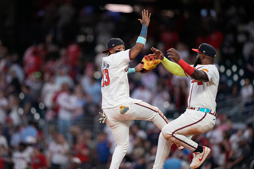 Atlanta Braves' Ronald Acuña Jr. (13) and Marcell Ozuna celebrate a win against the San Diego Padres, Monday, May 20, 2024, in Atlanta. (AP Photo/Brynn Anderson)