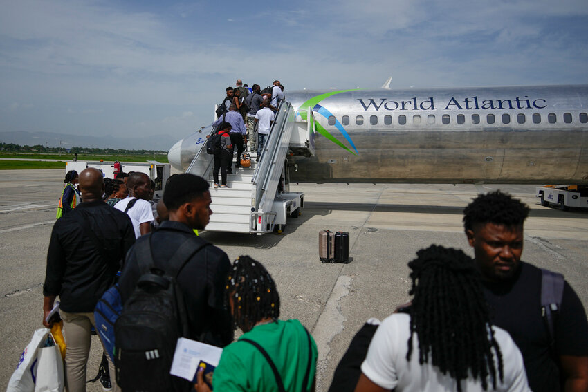 Passengers wait to board a World Atlantic plane at the Toussaint Louverture International Airport in Port-au-Prince, Haiti, Monday, May 20, 2024. (AP Photo/Ramon Espinosa)