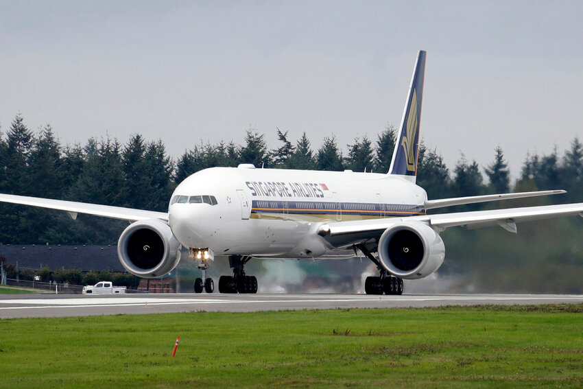 A Singapore Airlines Boeing 777-312ER readies to take off from Paine Field Tuesday, Sept. 17, 2013, in Everett, Wash. Singapore Airlines said on Tuesday, May 21, 2024, a person died aboard and others were injured when a London-Singapore flight encountered severe turbulence. (AP Photo/Elaine Thompson)