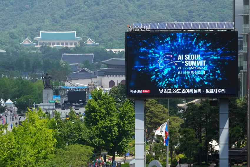 A screen shows an announcement of the AI Seoul Summit in Seoul, South Korea, Tuesday, May 21, 2024. World leaders are expected to adopt a new agreement on artificial intelligence when they gather virtually Tuesday to discuss AI’s potential risks but also ways to promote its benefits and innovation. (AP Photo/Ahn Young-joon)