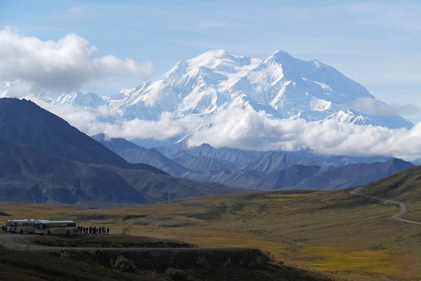 FILE - Sightseeing buses and tourists are seen at a pullout popular for taking in views of North America's tallest peak, Denali, in Denali National Park and Preserve, Alaska, Aug. 26, 2016. A Malaysian climber who died near the top of North America's tallest mountain while sheltering in a snow cave was identified by park officials Saturday, June 1, 2024. (AP Photo/Becky Bohrer, File)