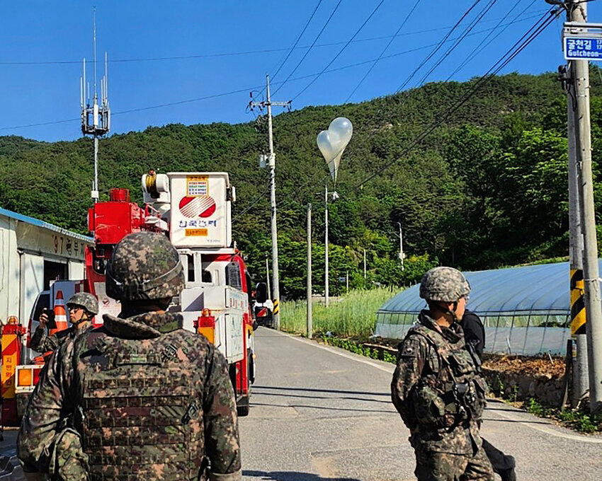FILE - In this photo provided by Jeonbuk Fire Headquarters, balloons with trash presumably sent by North Korea, hang on electric wires as South Korean army soldiers stand guard in Muju, South Korea, on Wednesday, May 29, 2024. North Korea launched more trash-carrying balloons toward the South after a similar campaign earlier in the week, according to South Korea's military, in what Pyongyang calls retaliation for activists flying anti-North Korean leaflets across the border. (Jeonbuk Fire Headquarters via AP, File)