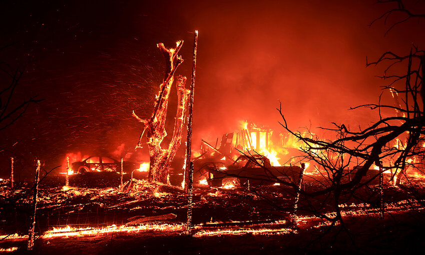 A home burns during the Corral Fire west of Tracy, Calif., Saturday, June 1, 2024. (Kent Porter/The Press Democrat via AP)