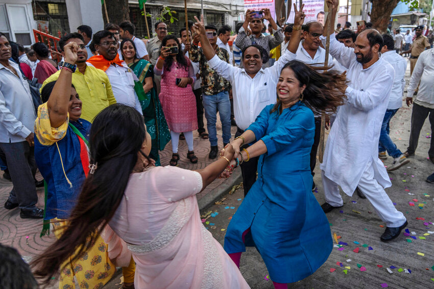 Supporters of the Congress Party dance as they celebrate their party's lead during the counting of votes in India's national election in Mumbai, India, Tuesday, June 4, 2024. (AP Photo/Rafiq Maqbool)