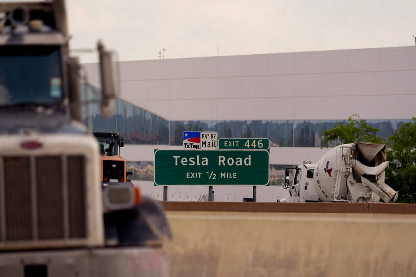 Vehicles pass the Tesla Gigafactory, Thursday, June 13, 2024, in Austin, Texas. (AP Photo/Eric Gay)