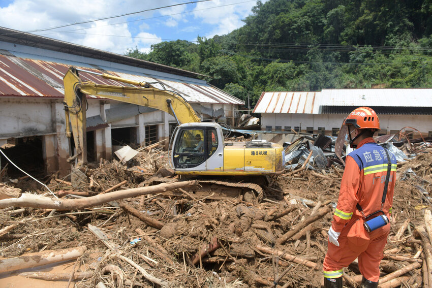 Rescuers clear debris in a flood-affected area in southern China, June 20, 2024. (Lu Hanxin/Xinhua via AP)