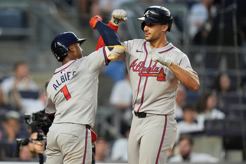Atlanta Braves' Matt Olson, right, celebrates with Ozzie Albies after they scored on a home run by Olson against the New York Yankees during the fourth inning Friday, June 21, 2024, in New York. (AP Photo/Frank Franklin II)