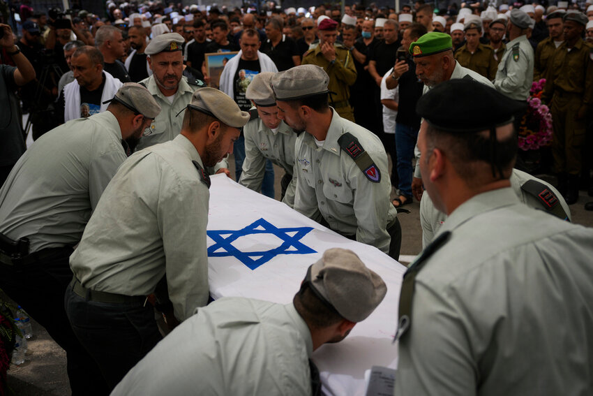 Israeli soldiers carry the flag-draped casket of Capt. Wassem Mahmoud during his funeral in the village of Beit Jann, northern Israel, June 16, 2024. (AP Photo/Ohad Zwigenberg, File)