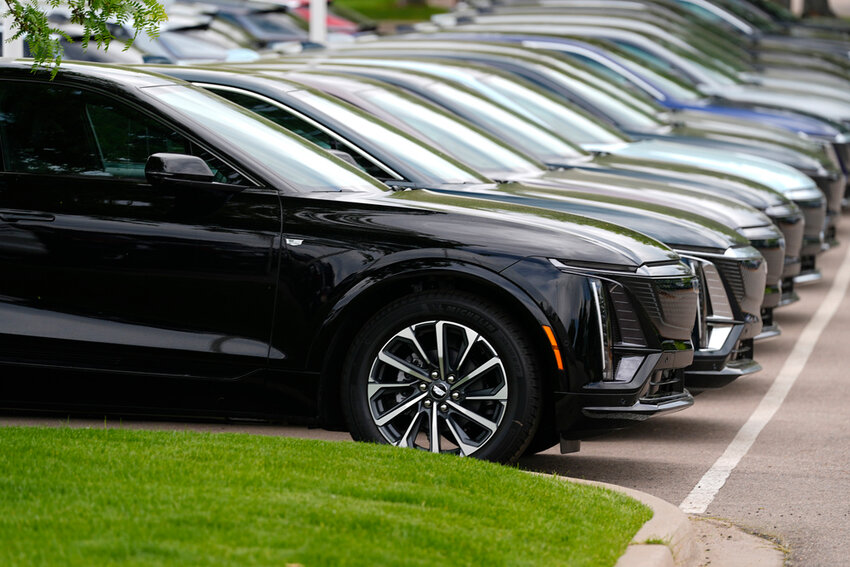 Vehicles sit in a row outside a dealership, June 2, 2024, in Lone Tree, Colo. (AP Photo/David Zalubowski, File)