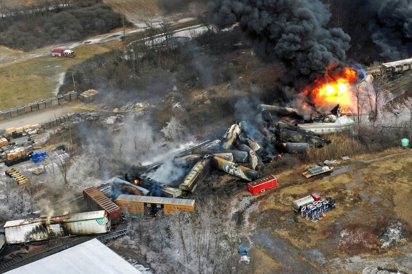 Debris from a Norfolk Southern freight train lies scattered and burning along the tracks on Feb. 4, 2023, the day after it derailed in East Palestine, Ohio. (AP Photo/Gene J. Puskar, File)