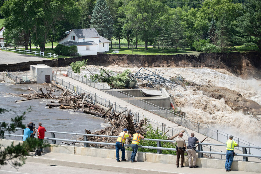 Onlookers take in the catastrophic damage to the Rapidan Dam site in Rapidan, Minn., Monday, June 24, 2024. (Casey Ek/The Free Press via AP)