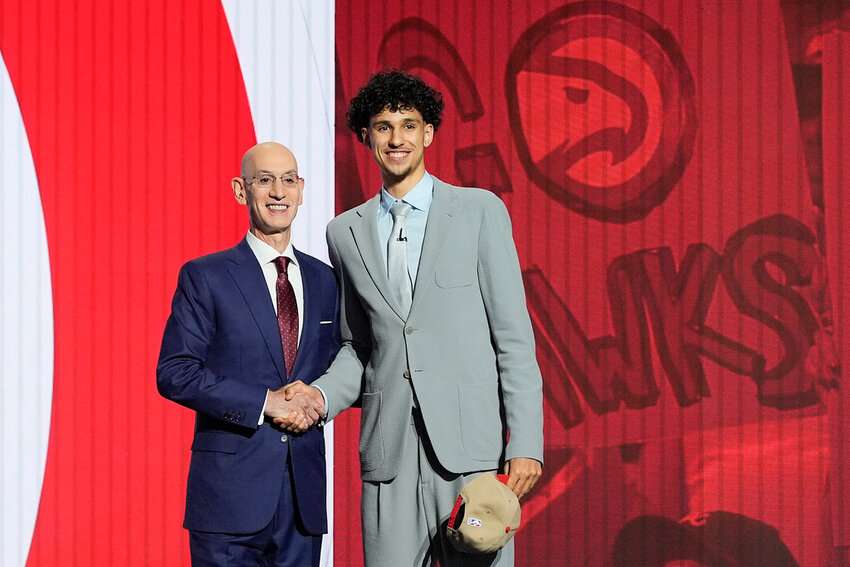 Zaccharie Risacher, right, poses for a photo with NBA commissioner Adam Silver after being selected as the first overall pick by the Atlanta Hawks in the first round of the draft Wednesday, June 26, 2024, in New York. (AP Photo/Julia Nikhinson)