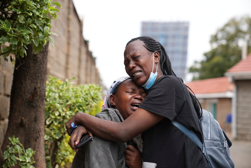 Edith Wanjiku, left, weeps after viewing the body of her son, who was allegedly shot by police during Tuesday's protest, at a Nairobi funeral home in Kenya Wednesday, June 26, 2024. (AP Photo/Brian Inganga)