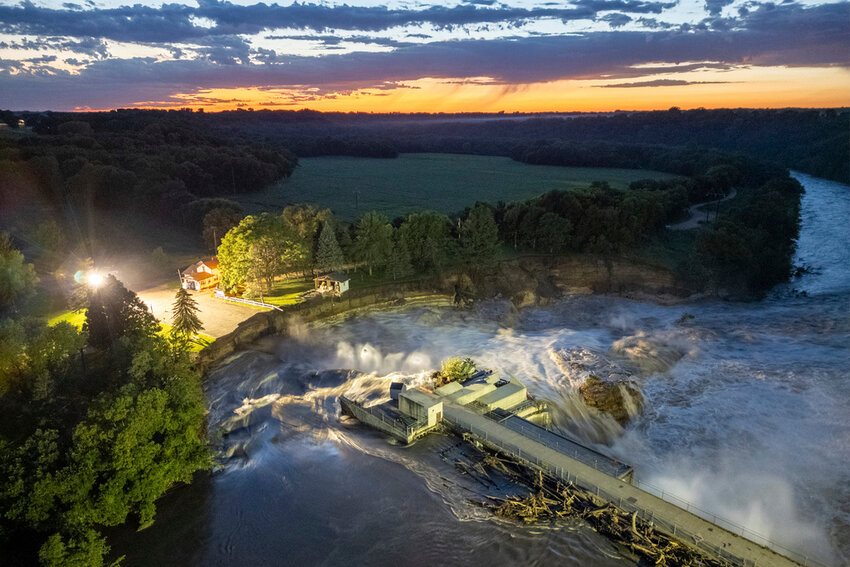 This long-exposure drone photo shows a home as it teeters before partially collapsing into the Blue Earth River at the Rapidan Dam in Rapidan, Minn., Tuesday, June 25, 2024. (Andrew Weinzierl/AW Aerial via AP)