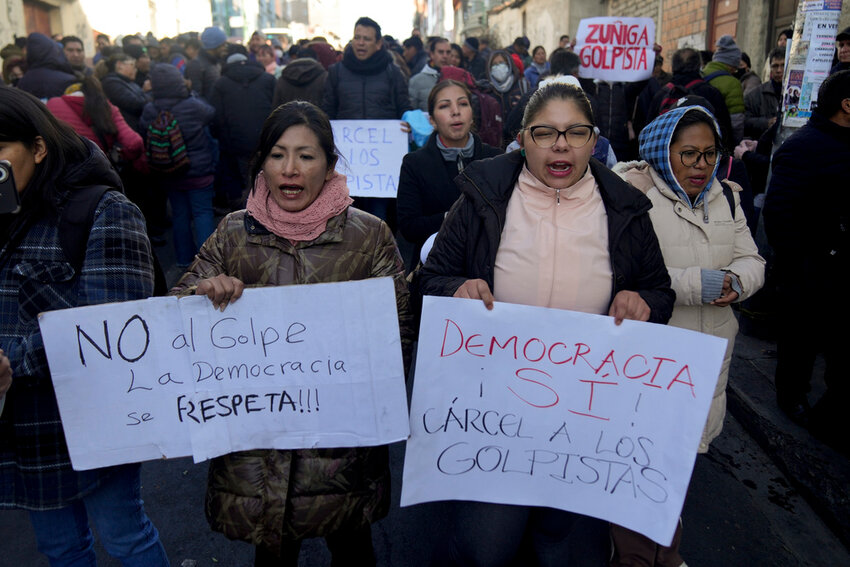 Supporters of Bolivian President Luis Arce protest against the now-ousted Bolivian army chief who led some soldiers to storm the presidential palace, outside police offices in La Paz, Bolivia, Thursday, June 27, 2024. The signs read in Spanish, 
