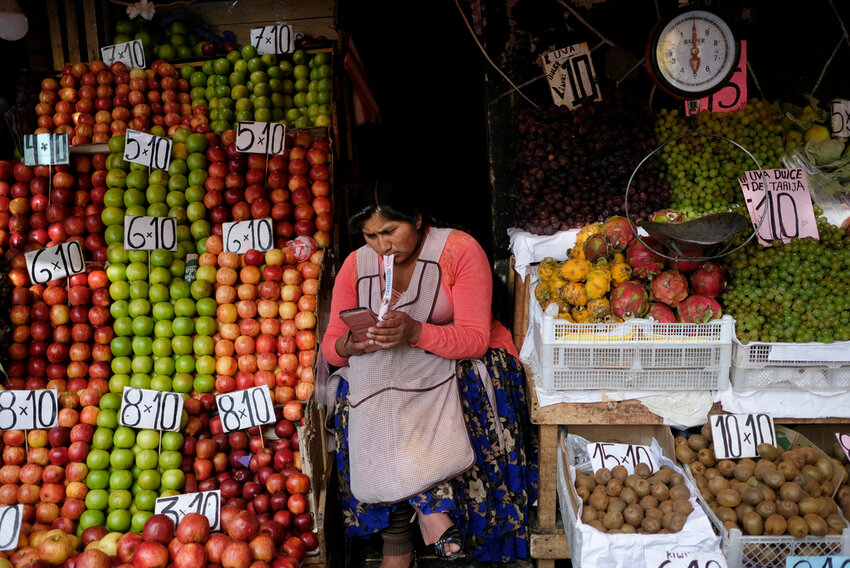 A vendor waits for customers at her produce stand, a day after Army troops stormed the government palace in what President Luis Arce called a coup attempt, in La Paz, Bolivia, Thursday, June 27, 2024. (AP Photo/Carlos Sanchez)