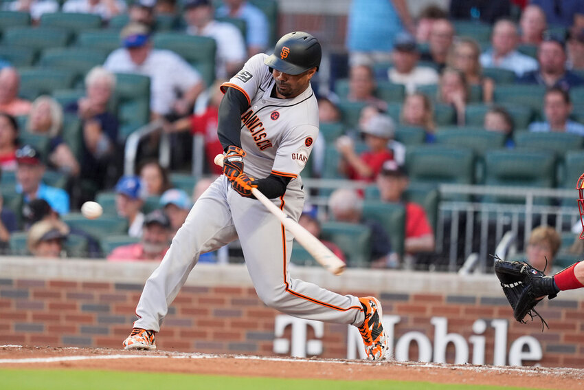 San Francisco Giants' LaMonte Wade Jr. (31) hits a solo home run in the fifth inning against the Atlanta Braves, Tuesday, July 2, 2024, in Atlanta. (AP Photo/Brynn Anderson)