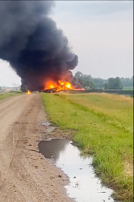 This photo provided by Doug Zink, smoke fills the sky after a train derailment on Friday, July 5, 2024 near Carrington, N.D.   Rail cars containing hazardous material derailed and burst into flames early Friday in a remote area of North Dakota, but emergency officials say no one was hurt and the threat to those living nearby appears to be minimal. (Doug Zink via AP)