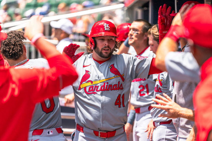 St. Louis Cardinals' Alec Burleson (41) celebrates in the dugout after hitting a home run in the third inning against the Atlanta Braves, Sunday, July 21, 2024, in Atlanta. (AP Photo/Jason Allen)