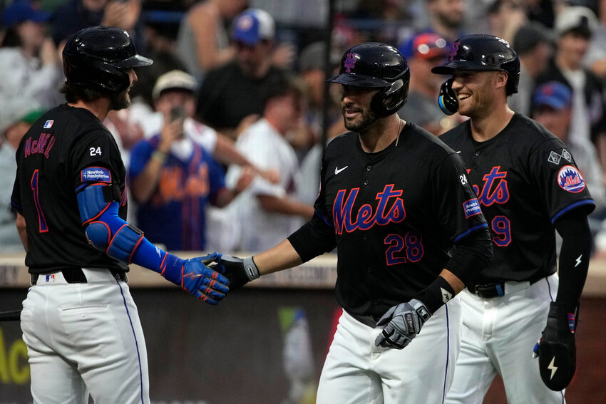 New York Mets' Jeff McNeil, left, J.D. Martinez, center, and Brandon Nimmo, right, celebrate after Martinez hit a grand slam during the third inning against the Atlanta Braves, Friday, July 26, 2024, in New York. (AP Photo/Pamela Smith)