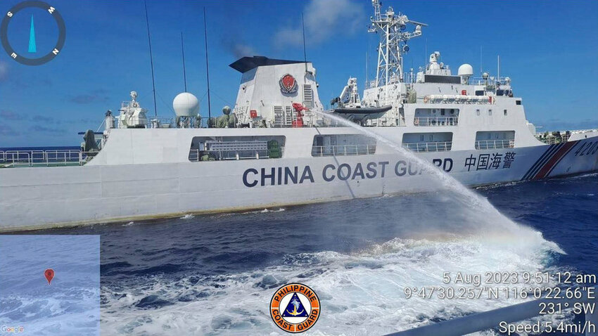 FILE - In this handout photo provided by the Philippine Coast Guard, a Chinese coast guard ship uses water canons on a Philippine Coast Guard ship near the Philippine-occupied Second Thomas Shoal, South China Sea as they blocked it's path during a re-supply mission on Aug. 5, 2023. (Philippine Coast Guard via AP, File)