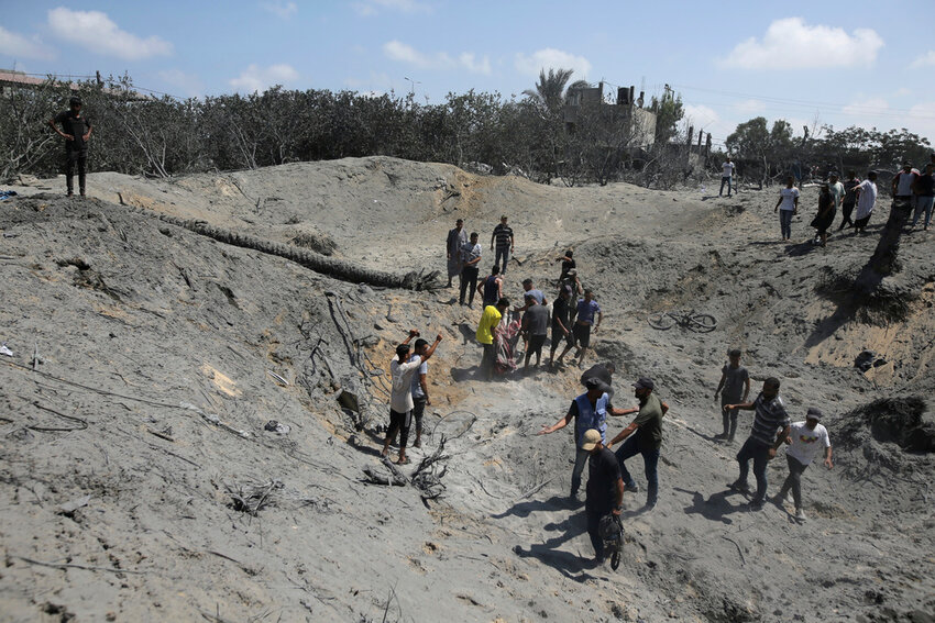Palestinians search for bodies and survivors in a site hit by an Israeli bombardment on Khan Younis, southern Gaza Strip, July 13, 2024. (AP Photo/AP Photo, File)
