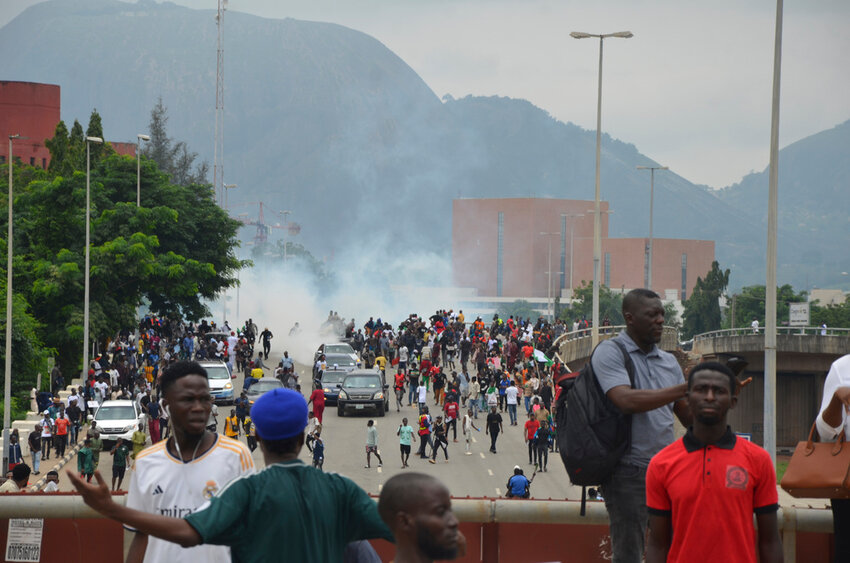 Police fire tear gas during a protest in Abuja, Nigeria, Thursday, Aug. 1, 2024.(AP Photo/Olamikan Gbemiga )