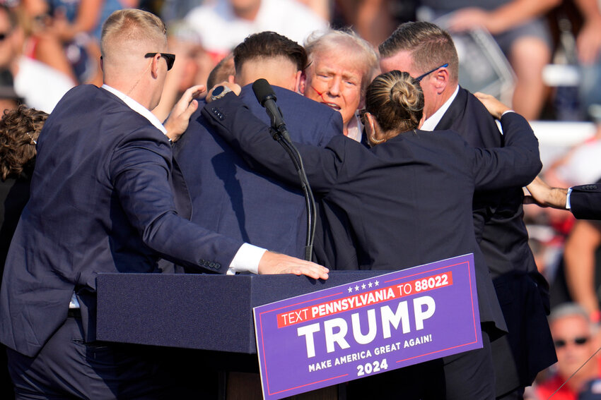 Republican presidential candidate former President Donald Trump is surrounded by Secret Service at a campaign event in Butler, Pa., July 13, 2024. (AP Photo/Gene J. Puskar, File)