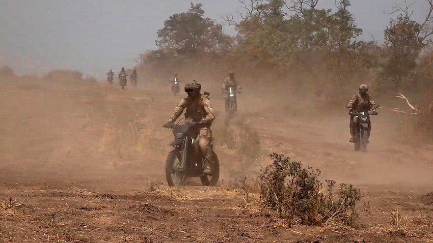 Marine assault team members ride motorcycles toward a Ukrainian position at an undisclosed location. (Russian Defense Ministry Press Service photo via AP)