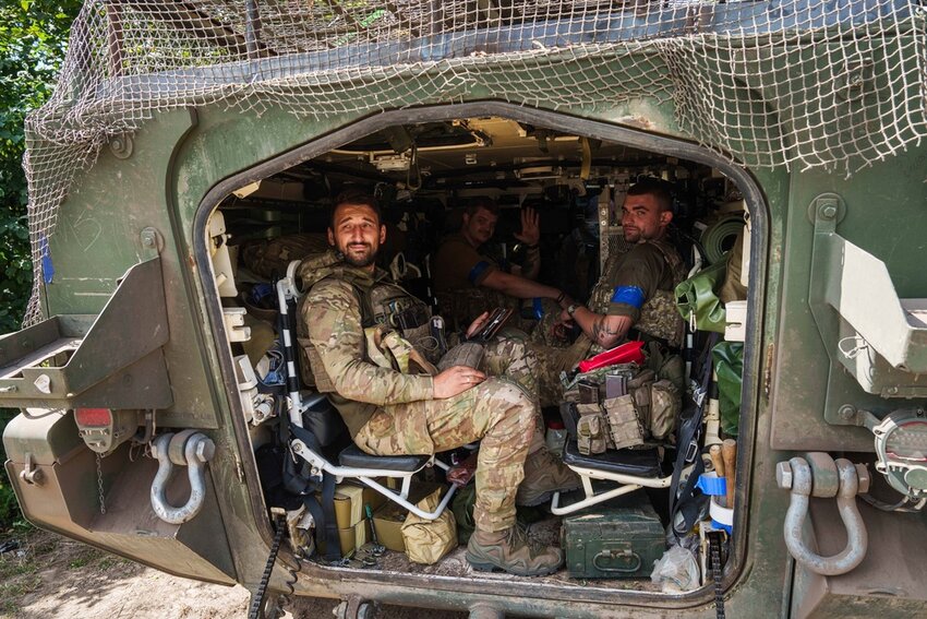 Ukrainian servicemen sit inside their APC after returning from Russia's Kursk region, near the Russian-Ukrainian border in Ukraine, Wednesday, Aug. 14, 2024. (AP Photo/Evgeniy Maloletka)