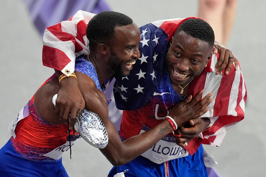 Gold medalist Grant Holloway, right, celebrates with silver medalist Daniel Roberts at the end of the men's 110-meter hurdles final at the 2024 Summer Olympics, Thursday, Aug. 8, 2024, in Saint-Denis, France. (AP Photo/Rebecca Blackwell)