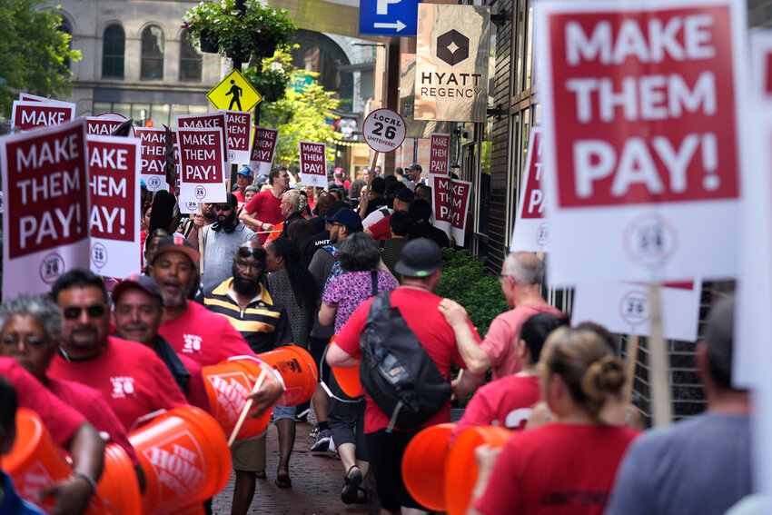 Union members from Local 26, representing workers in the hospitality industries of Massachusetts, picket outside the Hyatt Regency Boston, Wednesday, July 17, 2024, in Boston. (AP Photo/Charles Krupa)