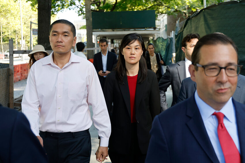 Attorney Seth DuCharme walks in front of former New York Governor Kathy Hochul aide Linda Sun, center, and her husband, Christopher Hu, left, leaving Brooklyn Federal Court after their arraignment, Tuesday, Sept. 3, 2024, in New York. (AP Photo/Corey Sipkin)