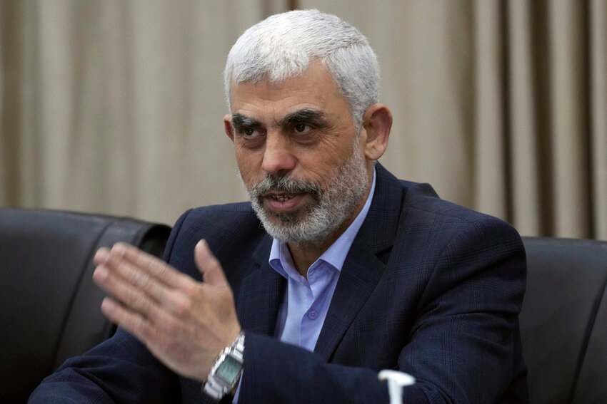 Yahya Sinwar, head of Hamas in Gaza, greets supporters during a meeting with leaders of Palestinian factions at his office in Gaza City, April 13, 2022.  (AP Photo/Adel Hana)