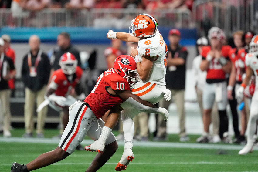 Clemson quarterback Cade Klubnik (2) is hit by Georgia linebacker Damon Wilson II after releasing a pass during the second half Aug. 31, 2024, in Atlanta. (AP Photo/John Bazemore)