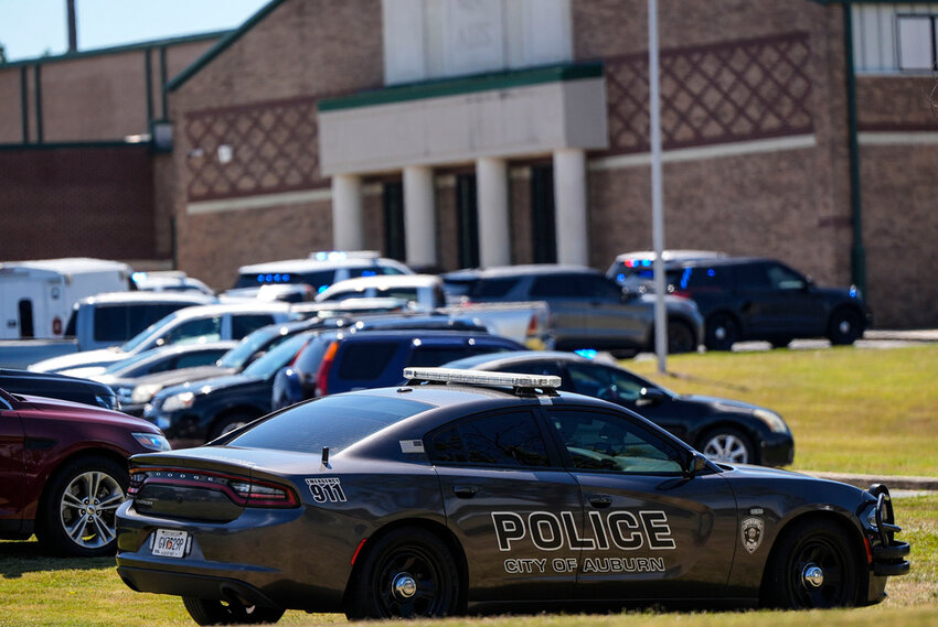 Police vehicles are seen outside Apalachee High School after a shooting Wednesday, Sept. 4, 2024, in Winder, Ga. (AP Photo/Mike Stewart)