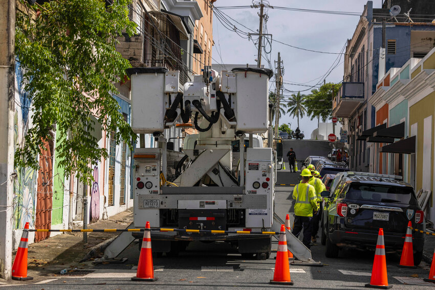 Electric workers carry out repairs in the community of Puerta de Tierra after the passage of Tropical Storm Ernesto in San Juan, Puerto Rico, Aug. 15, 2024. (AP Photo/Alejandro Granadillo)