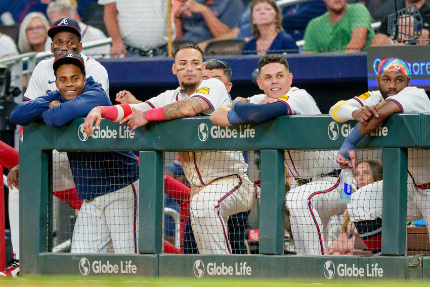 Atlanta Braves outfielder Jorge Soler, far left, pitcher Raisel Iglesias, left with blue sweatshirt, shortstop Orlando Arcia center left, third baseman Gio Urshela, center right, and outfielder Michael Harris II, right, watch Marcell Ozuna at bat in the ninth inning against the Colorado Rockies, Thursday, Sept. 5, 2024, in Atlanta. (AP Photo/Jason Allen)